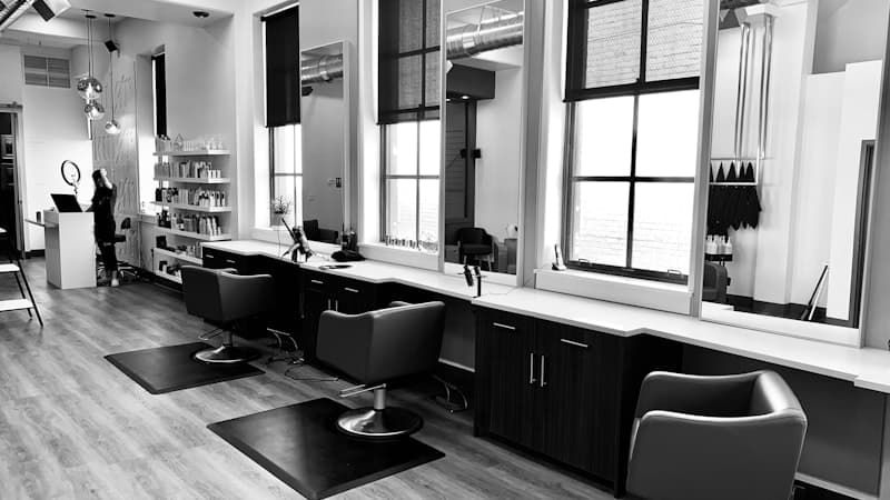 Salon stylist working on client hair treatment